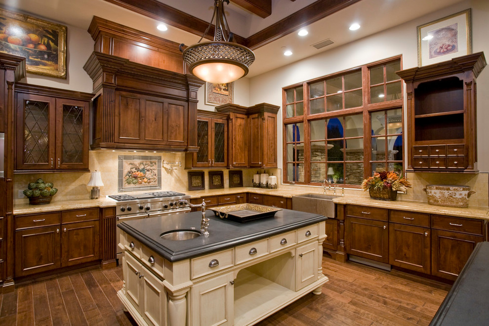 Elegant u-shaped dark wood floor kitchen photo in Phoenix with a farmhouse sink, recessed-panel cabinets, dark wood cabinets, beige backsplash, ceramic backsplash, paneled appliances and two islands
