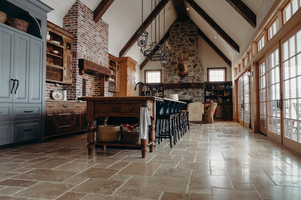 Inspiration for a large cottage single-wall porcelain tile and brown floor eat-in kitchen remodel in Seattle with a farmhouse sink, recessed-panel cabinets, blue cabinets, granite countertops, multicolored backsplash, brick backsplash, stainless steel appliances and an island