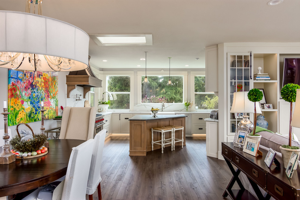 Huge cottage galley vinyl floor and brown floor eat-in kitchen photo in Portland with a farmhouse sink, shaker cabinets, white cabinets, quartz countertops, white backsplash, stone slab backsplash, stainless steel appliances, an island and white countertops