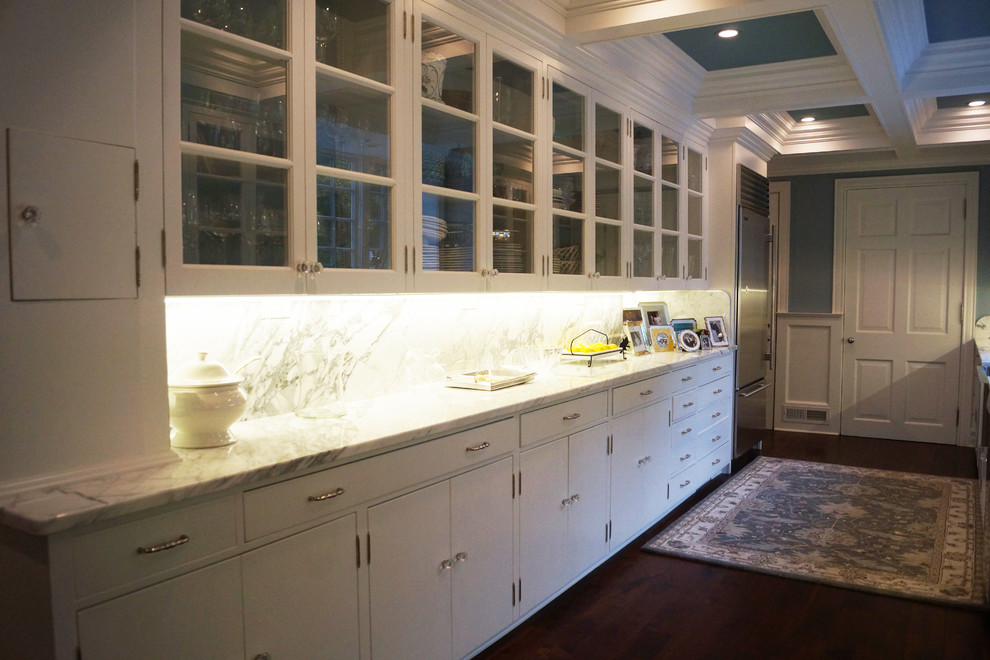 Large classic kitchen/diner in Grand Rapids with a belfast sink, beaded cabinets, white cabinets and an island.