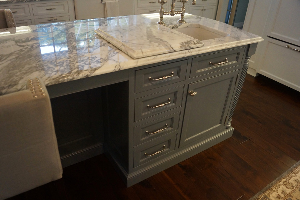 Inspiration for a large traditional kitchen/diner in Grand Rapids with a belfast sink, beaded cabinets, white cabinets and an island.