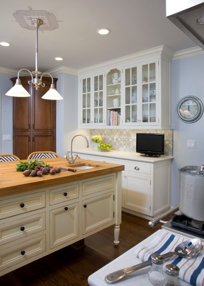 Inspiration for a mid-sized transitional u-shaped medium tone wood floor enclosed kitchen remodel in San Diego with a farmhouse sink, recessed-panel cabinets, yellow cabinets, wood countertops, blue backsplash, mosaic tile backsplash, colored appliances and an island
