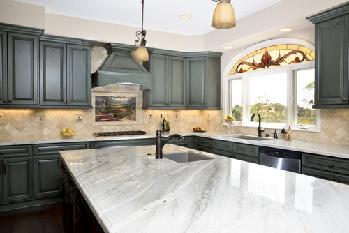 Farmhouse kitchen with white cabinetry, rustic wooden shelves, and Taj Mahal quartzite countertops, enhanced by vintage-style fixtures