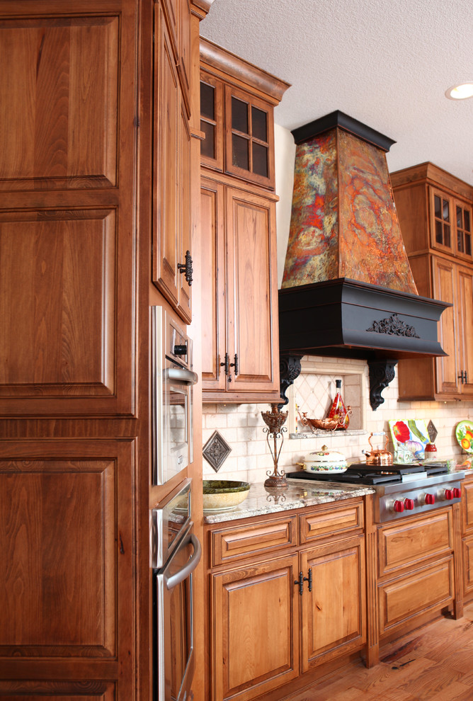 Photo of a rural kitchen in Denver with raised-panel cabinets and medium wood cabinets.