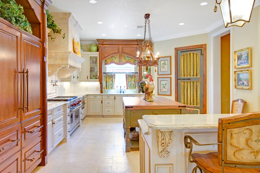 Example of a french country kitchen design in Orlando with paneled appliances