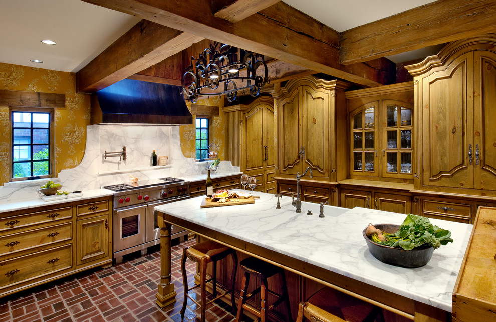 French country kitchen photo in Other with raised-panel cabinets, stainless steel appliances and marble countertops