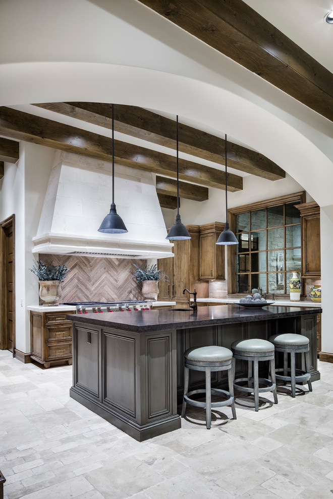 Example of a large tuscan galley eat-in kitchen design in Austin with recessed-panel cabinets and an island