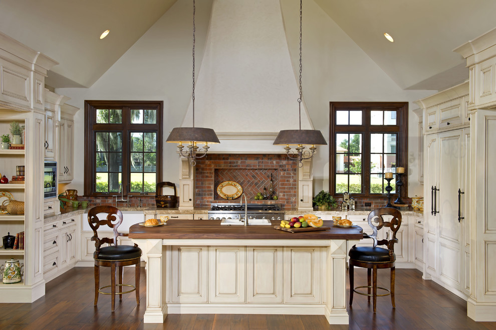 Inspiration for a timeless u-shaped kitchen remodel in Orlando with raised-panel cabinets, beige cabinets and paneled appliances