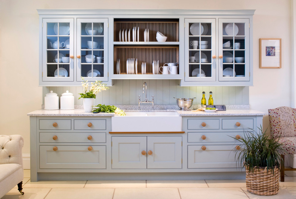 Cottage kitchen photo in Oxfordshire with a farmhouse sink, recessed-panel cabinets, blue cabinets and blue backsplash