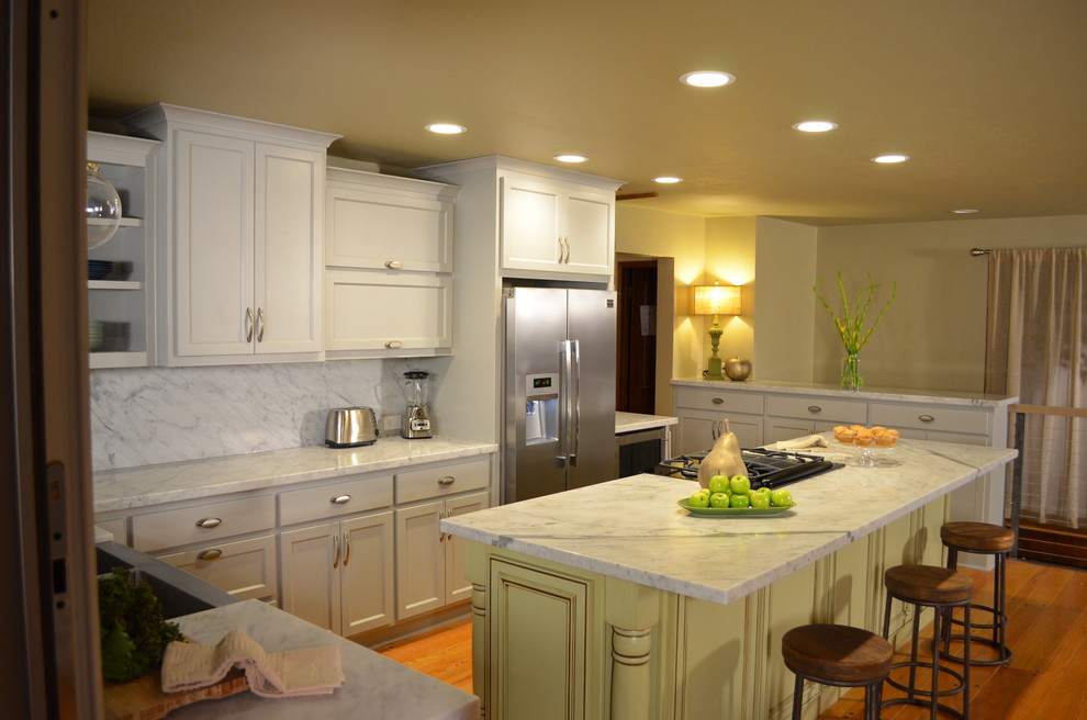 Mid-sized transitional l-shaped light wood floor eat-in kitchen photo in Sacramento with a farmhouse sink, shaker cabinets, gray cabinets, stone slab backsplash, stainless steel appliances and an island
