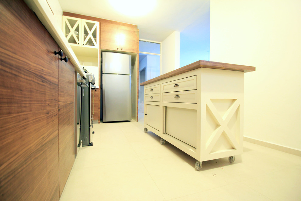 Example of a mid-sized classic l-shaped ceramic tile enclosed kitchen design in Other with a drop-in sink, flat-panel cabinets, medium tone wood cabinets, solid surface countertops, white backsplash, ceramic backsplash, stainless steel appliances and an island