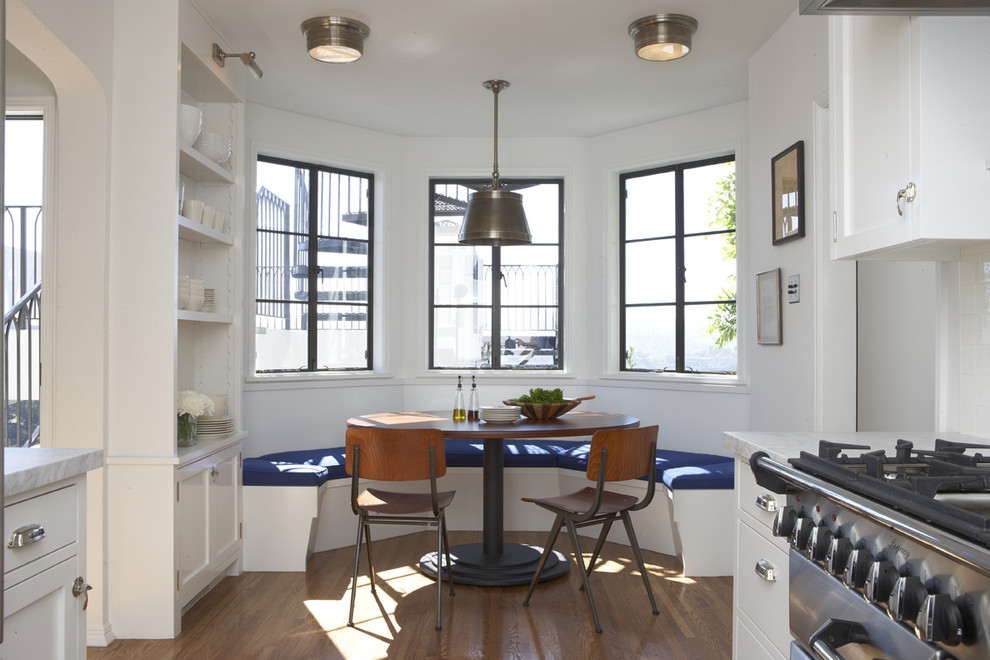 Eat-in kitchen - transitional eat-in kitchen idea in Los Angeles with white cabinets and stainless steel appliances
