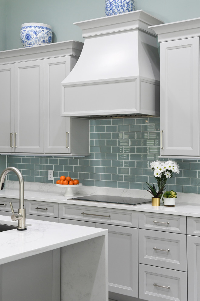 Eat-in kitchen - mid-sized traditional l-shaped porcelain tile and gray floor eat-in kitchen idea in Atlanta with an undermount sink, gray cabinets, solid surface countertops, blue backsplash, glass tile backsplash, stainless steel appliances, two islands and white countertops