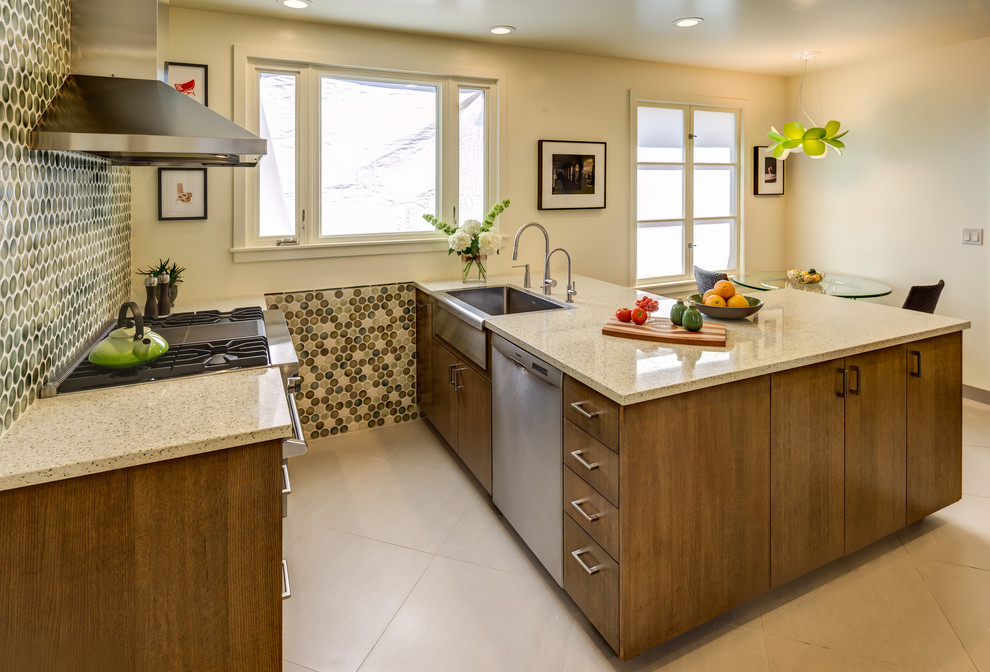 Inspiration for a small contemporary galley porcelain tile eat-in kitchen remodel in San Francisco with a single-bowl sink, flat-panel cabinets, brown cabinets, quartz countertops, green backsplash, mosaic tile backsplash, stainless steel appliances and no island