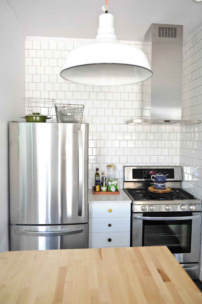 Example of an eclectic kitchen design in Vancouver with stainless steel appliances