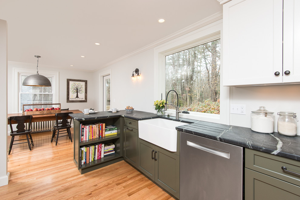 This is an example of a medium sized traditional l-shaped kitchen/diner in Boston with recessed-panel cabinets, green cabinets, soapstone worktops, white splashback, metro tiled splashback, stainless steel appliances and a breakfast bar.