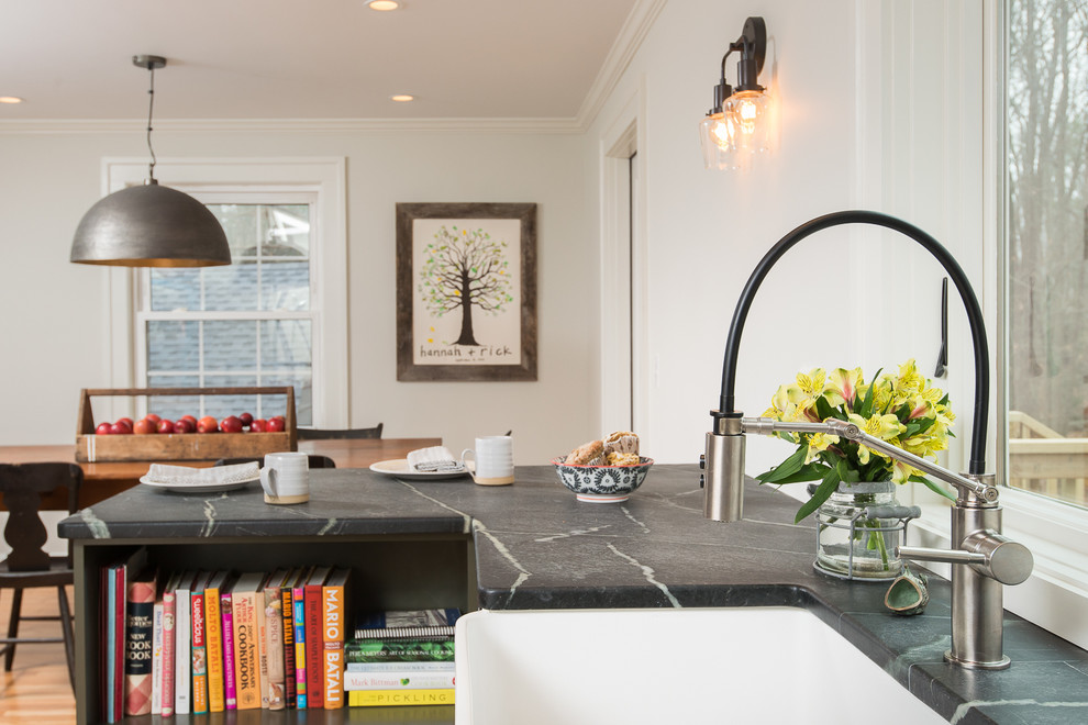 Mid-sized transitional l-shaped eat-in kitchen photo in Boston with recessed-panel cabinets, green cabinets, soapstone countertops, white backsplash, subway tile backsplash, stainless steel appliances and a peninsula