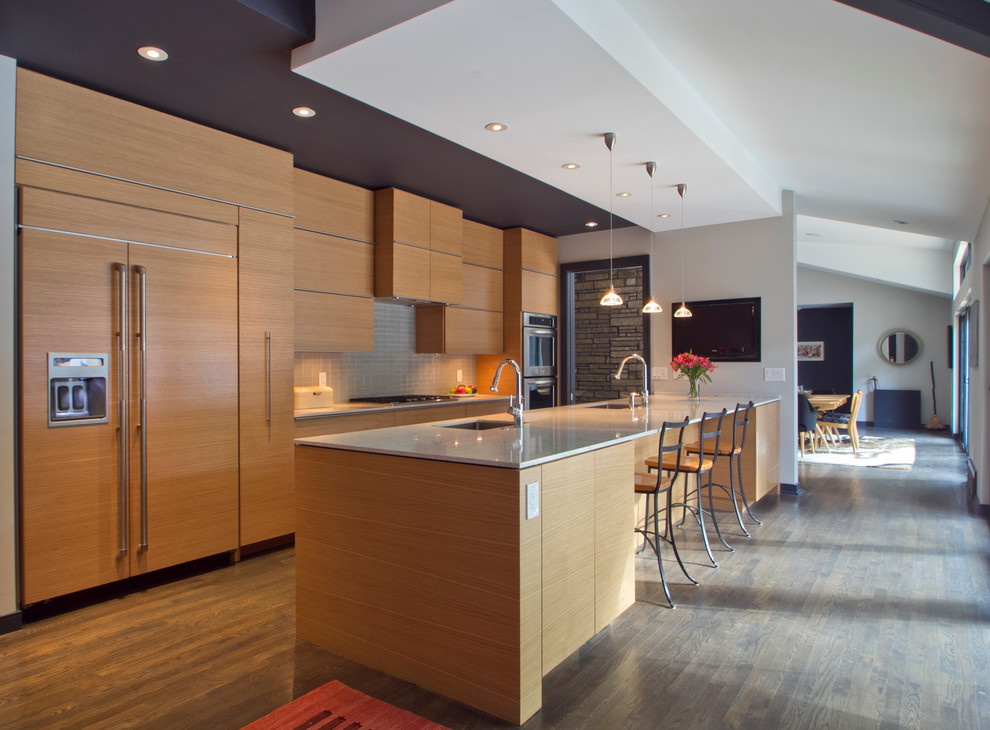Example of a mid-sized minimalist galley medium tone wood floor and brown floor eat-in kitchen design in Atlanta with flat-panel cabinets, medium tone wood cabinets, gray backsplash, paneled appliances, a single-bowl sink, ceramic backsplash, a peninsula and quartzite countertops