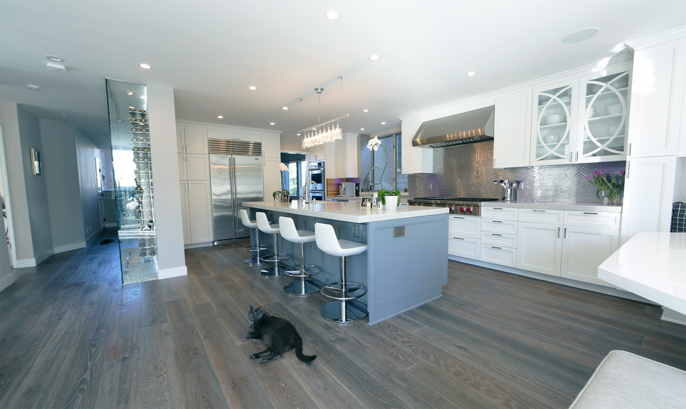 Kitchen - transitional medium tone wood floor kitchen idea in Los Angeles with an undermount sink, recessed-panel cabinets, white cabinets, quartz countertops, gray backsplash, metal backsplash, stainless steel appliances and an island