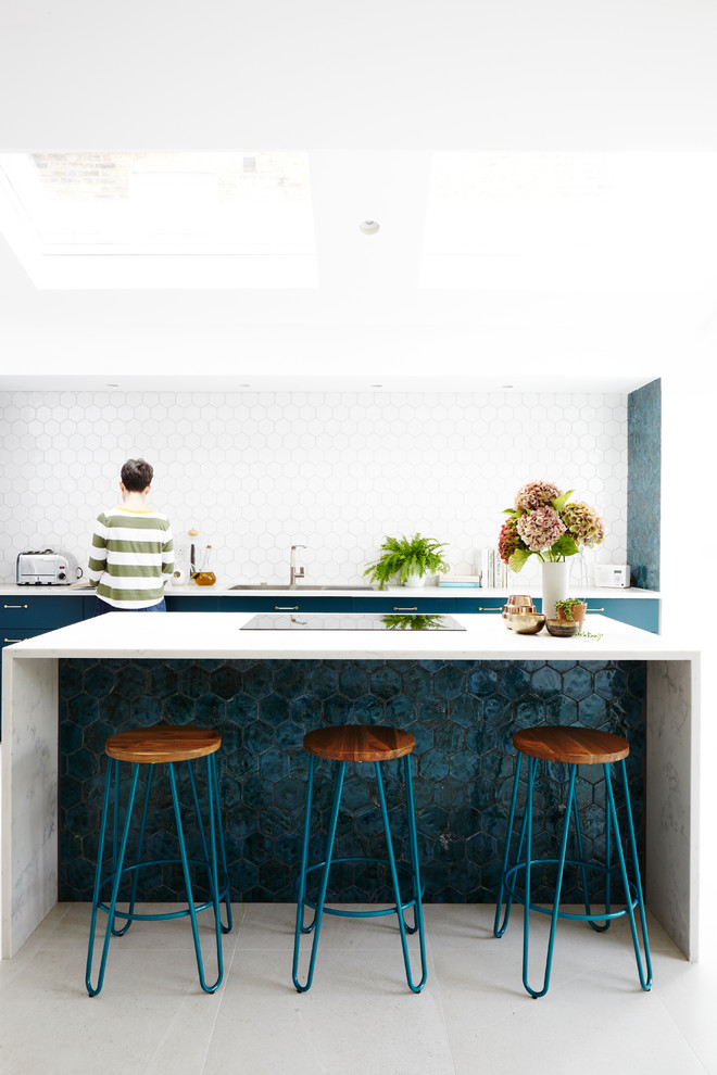 Foto på ett funkis vit kök med öppen planlösning, med en integrerad diskho, släta luckor, turkosa skåp, marmorbänkskiva, vitt stänkskydd, stänkskydd i keramik, klinkergolv i keramik, en köksö och grått golv
