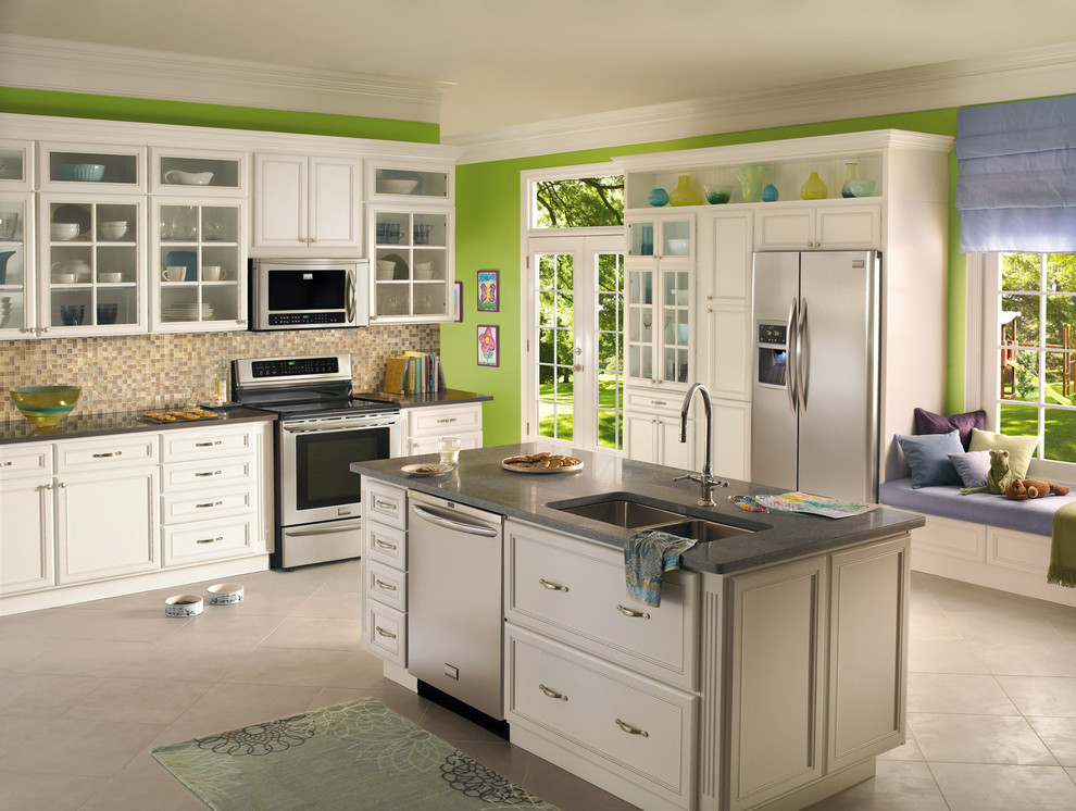 Example of a mid-sized eclectic galley slate floor kitchen pantry design in New York with a double-bowl sink, beaded inset cabinets, white cabinets, granite countertops, multicolored backsplash, ceramic backsplash, stainless steel appliances and an island