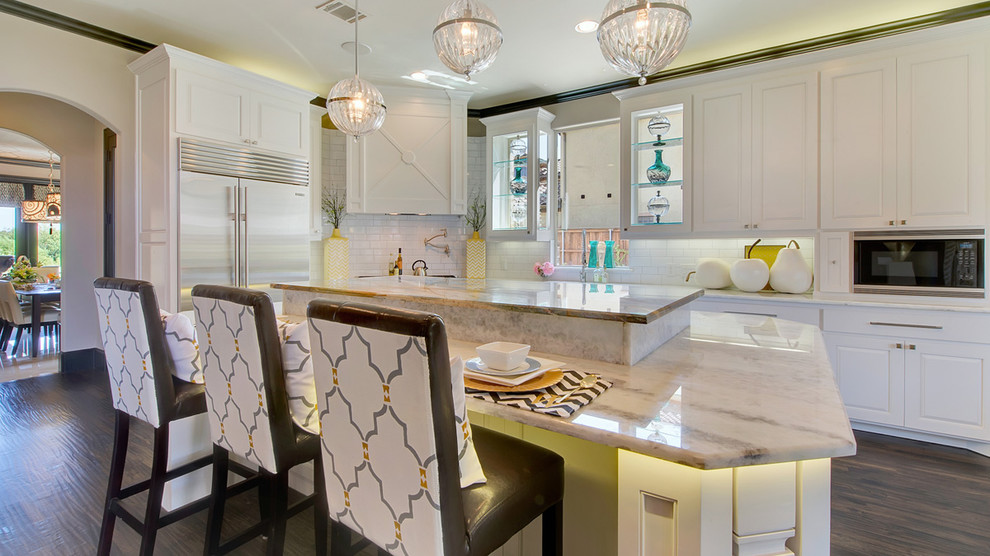 Photo of a modern kitchen in Dallas with raised-panel cabinets, white cabinets, granite worktops, white splashback, metro tiled splashback and stainless steel appliances.