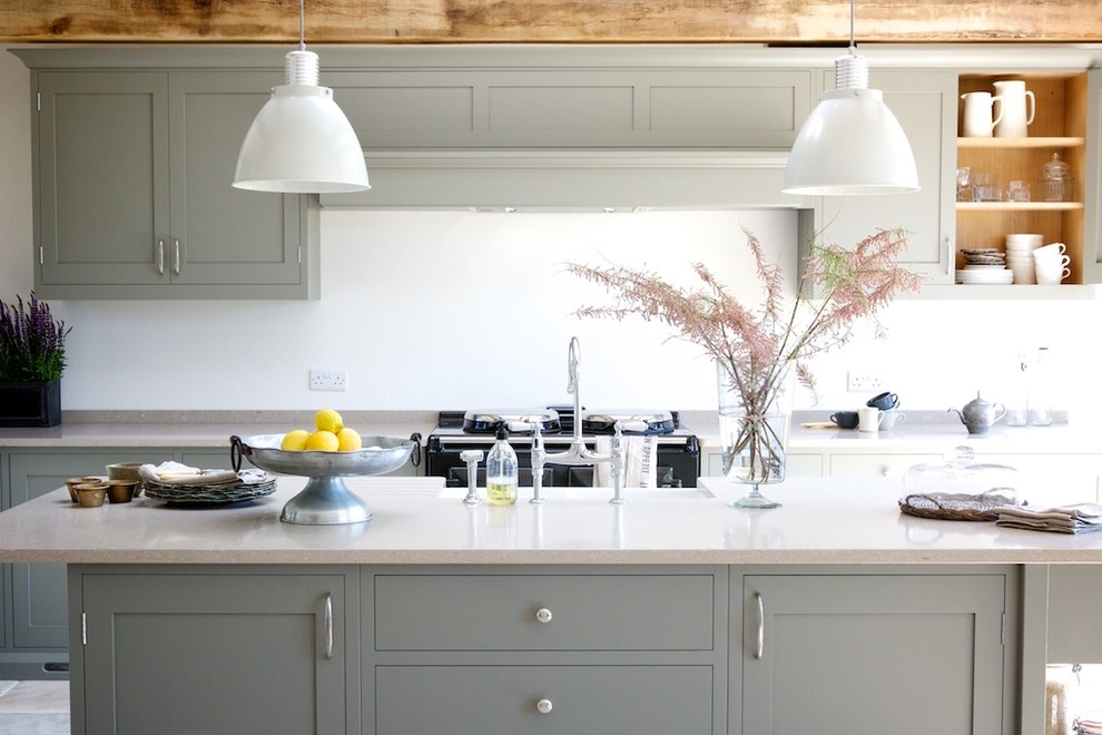 This is an example of a contemporary open plan kitchen in Sussex with an island.