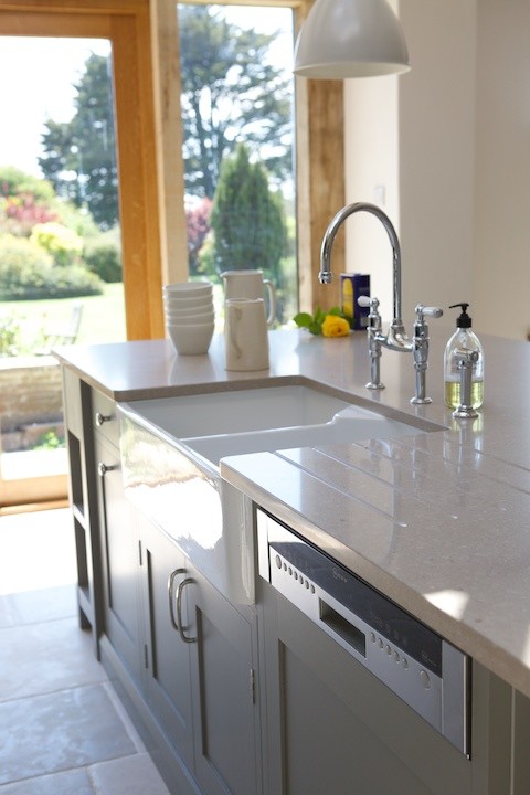 Example of a trendy open concept kitchen design in Sussex with an island
