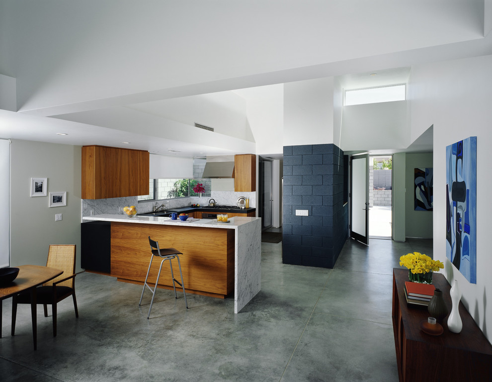 Large modern u-shaped open plan kitchen in Los Angeles with a submerged sink, flat-panel cabinets, medium wood cabinets, marble worktops, multi-coloured splashback, marble splashback, stainless steel appliances, limestone flooring, a breakfast bar and grey floors.