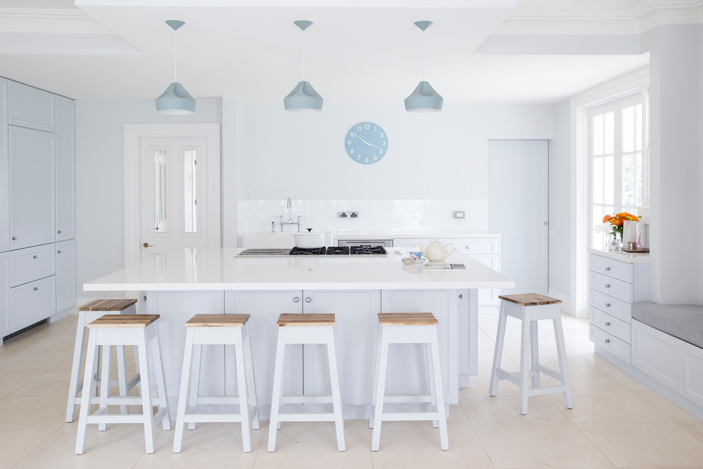 Design ideas for a large scandinavian galley kitchen in Sydney with white splashback, white appliances, an island, a belfast sink, shaker cabinets and white cabinets.