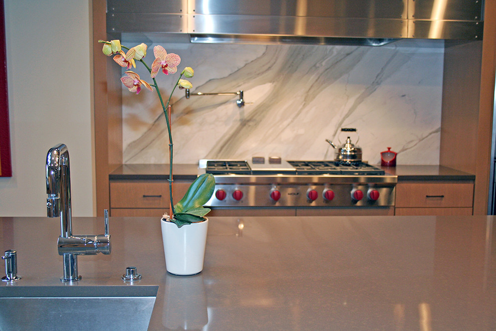 Huge minimalist u-shaped medium tone wood floor eat-in kitchen photo in Seattle with an undermount sink, flat-panel cabinets, light wood cabinets, quartz countertops, white backsplash, stone tile backsplash, paneled appliances and an island