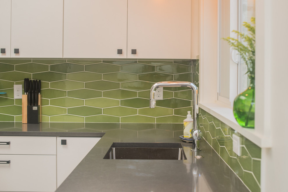 Inspiration for a mid-sized contemporary l-shaped eat-in kitchen remodel in Portland with an undermount sink, flat-panel cabinets, white cabinets, quartz countertops, green backsplash, ceramic backsplash, stainless steel appliances and no island