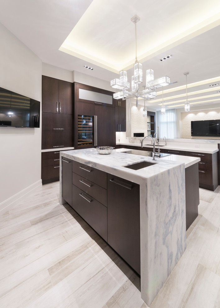 Example of a mid-sized minimalist u-shaped porcelain tile eat-in kitchen design in Miami with a drop-in sink, raised-panel cabinets, dark wood cabinets, quartz countertops, white backsplash, paneled appliances and an island