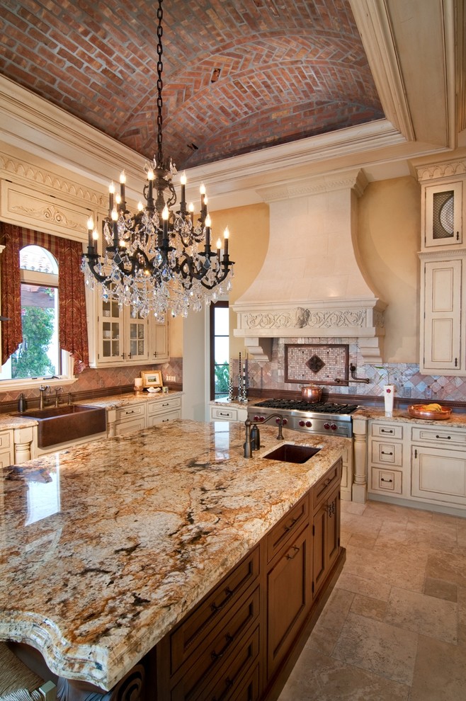 Example of a huge tuscan u-shaped marble floor enclosed kitchen design in Miami with a farmhouse sink, recessed-panel cabinets, light wood cabinets, granite countertops, multicolored backsplash, mosaic tile backsplash, stainless steel appliances and an island