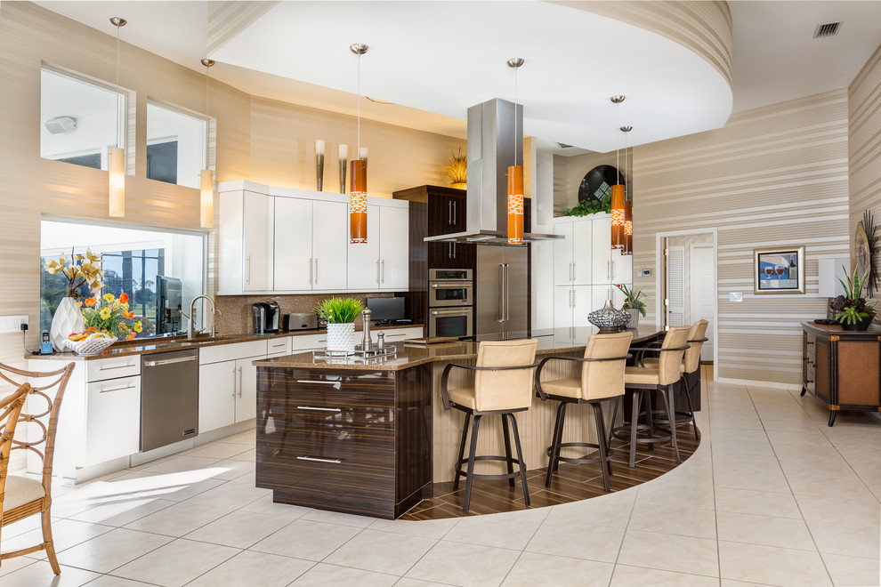 Eat-in kitchen - large contemporary u-shaped ceramic tile eat-in kitchen idea in Miami with a drop-in sink, flat-panel cabinets, white cabinets, stainless steel appliances, an island, quartz countertops, brown backsplash and matchstick tile backsplash