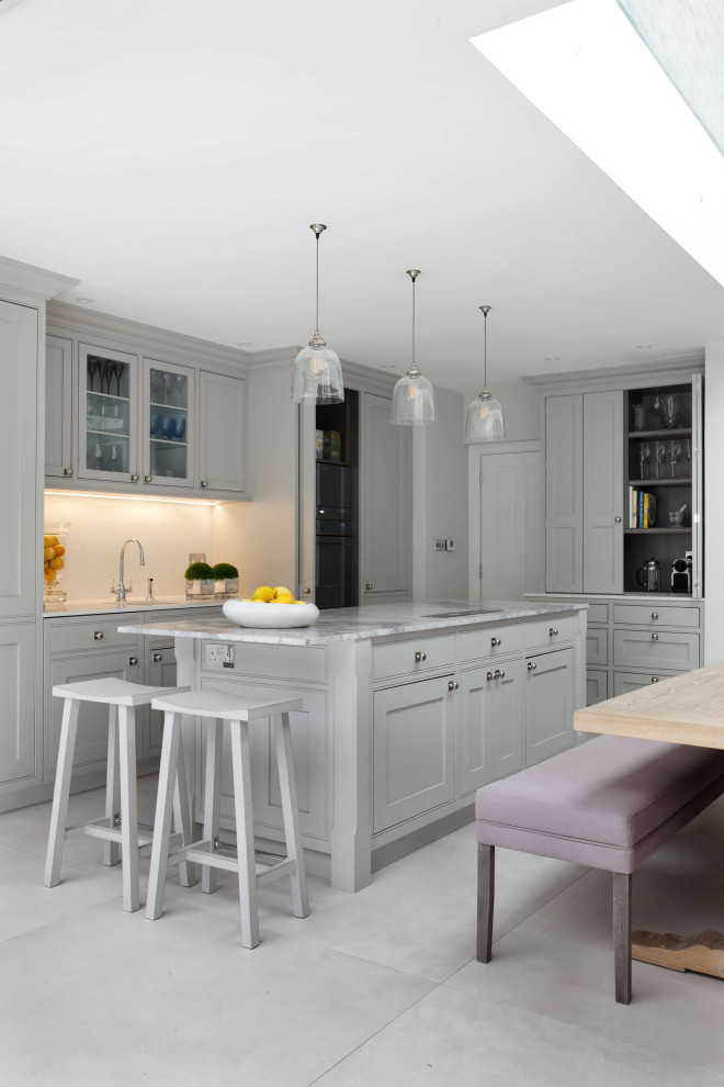 Large classic kitchen/diner in London with a single-bowl sink, marble worktops, an island, grey worktops, shaker cabinets, grey cabinets, stainless steel appliances, ceramic flooring and grey floors.