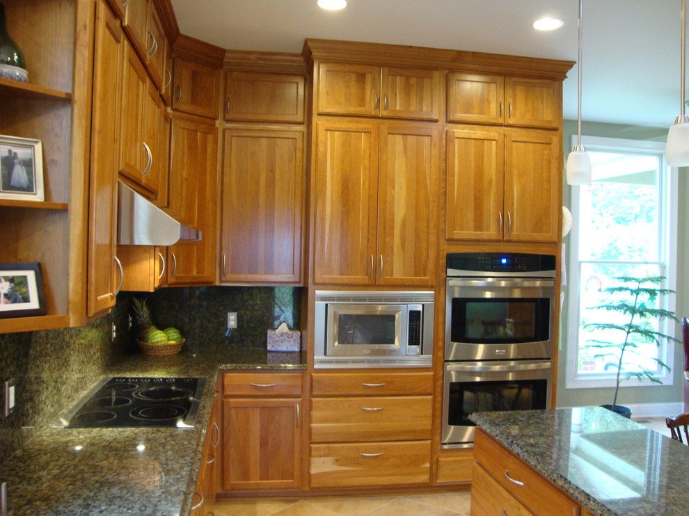 Esempio di una grande cucina design con ante in legno chiaro, top in granito, paraspruzzi verde, elettrodomestici in acciaio inossidabile e pavimento con piastrelle in ceramica