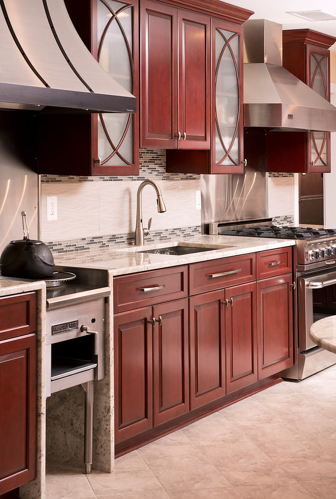 Example of a huge classic u-shaped enclosed kitchen design in Baltimore with a double-bowl sink, raised-panel cabinets, dark wood cabinets, stainless steel appliances and two islands