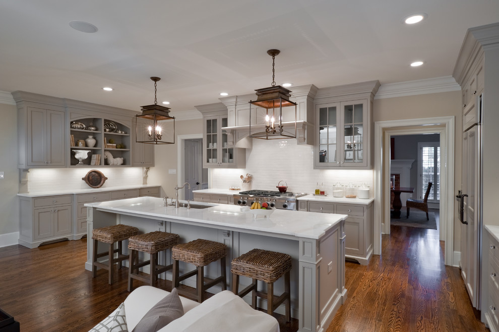 Inspiration for a timeless u-shaped open concept kitchen remodel in Charlotte with recessed-panel cabinets, gray cabinets, white backsplash, paneled appliances and white countertops