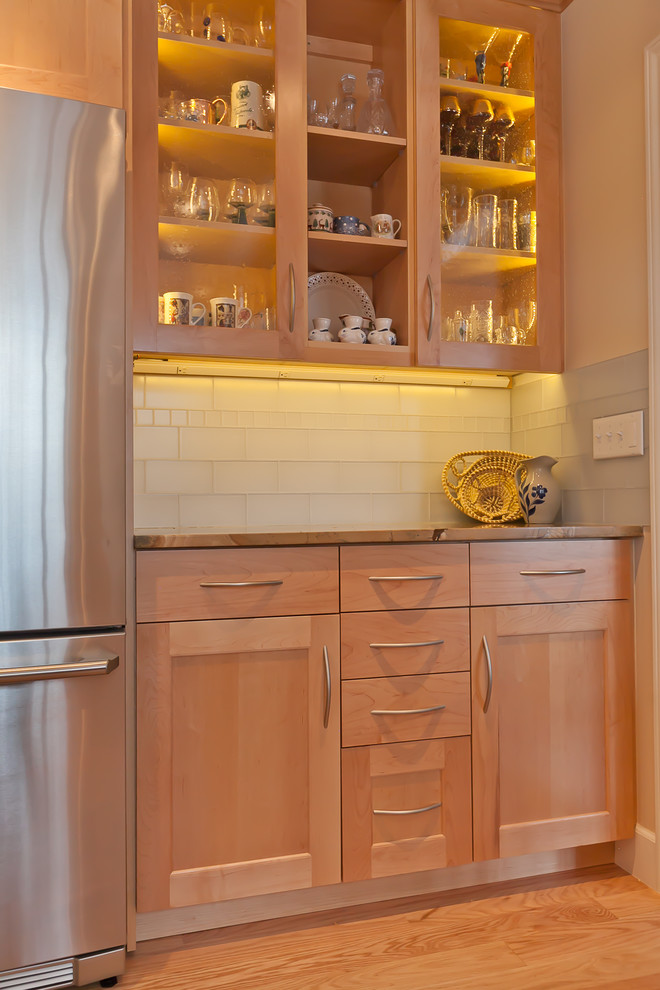 Mid-sized transitional light wood floor kitchen photo in Denver with an undermount sink, shaker cabinets, light wood cabinets, onyx countertops, white backsplash, subway tile backsplash and stainless steel appliances