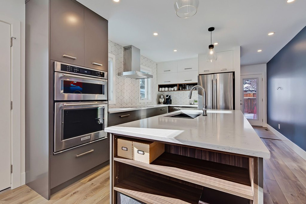 Eat-in kitchen - mid-sized contemporary l-shaped light wood floor and brown floor eat-in kitchen idea in Calgary with flat-panel cabinets, dark wood cabinets, white backsplash, an island, stainless steel appliances, a double-bowl sink and white countertops