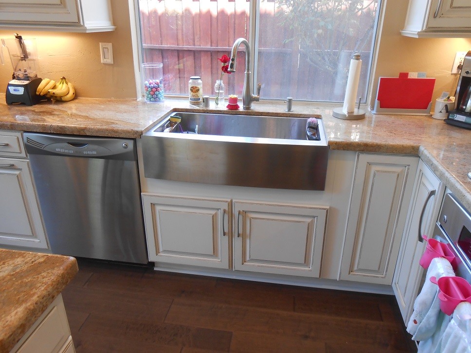 Example of a cottage dark wood floor kitchen design in San Diego with a farmhouse sink and granite countertops