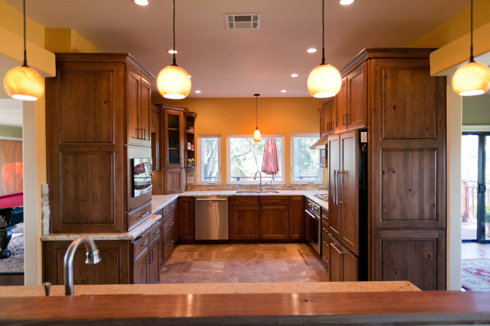 Mid-sized elegant u-shaped medium tone wood floor kitchen photo in San Luis Obispo with an undermount sink, raised-panel cabinets, medium tone wood cabinets and stainless steel appliances