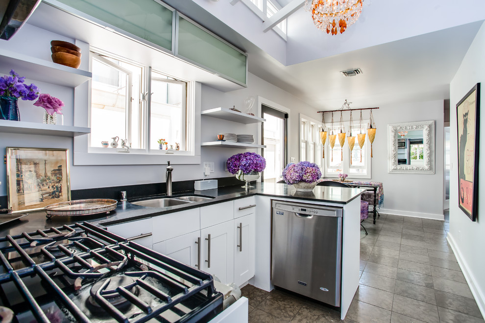 This is an example of a small contemporary u-shaped kitchen/diner in Los Angeles with a double-bowl sink, shaker cabinets, white cabinets, composite countertops, stainless steel appliances and no island.