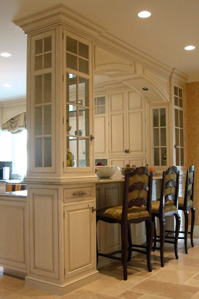 Elegant kitchen photo in Boston with glass-front cabinets and beige cabinets