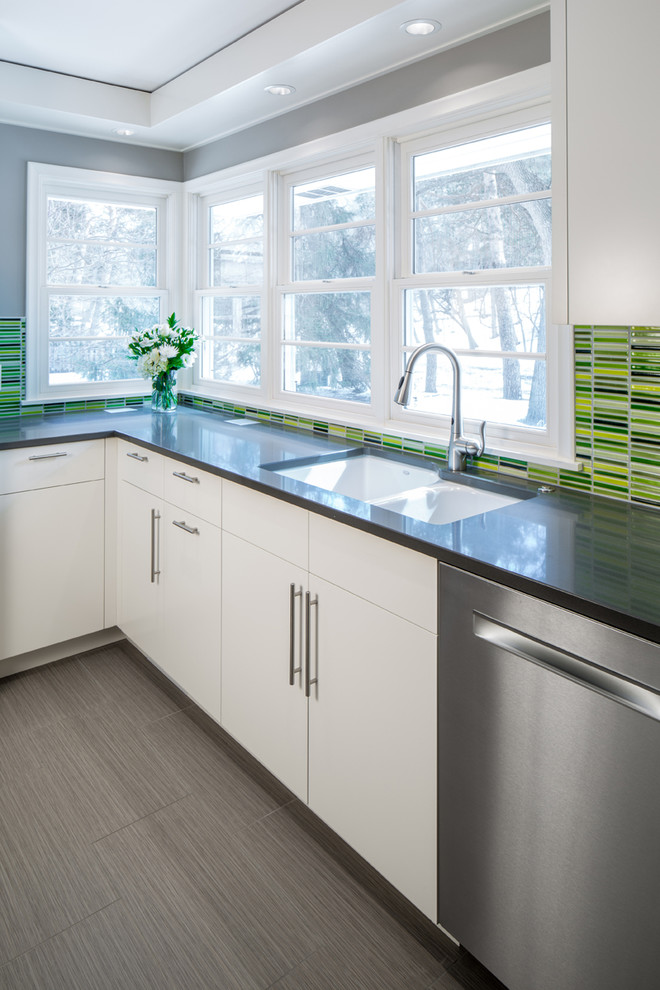 Design ideas for a contemporary kitchen in Minneapolis with a submerged sink, flat-panel cabinets, white cabinets, composite countertops, green splashback, porcelain splashback, stainless steel appliances, porcelain flooring and no island.