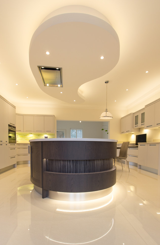 Photo of a traditional open plan kitchen in Essex with grey cabinets, glass sheet splashback and an island.