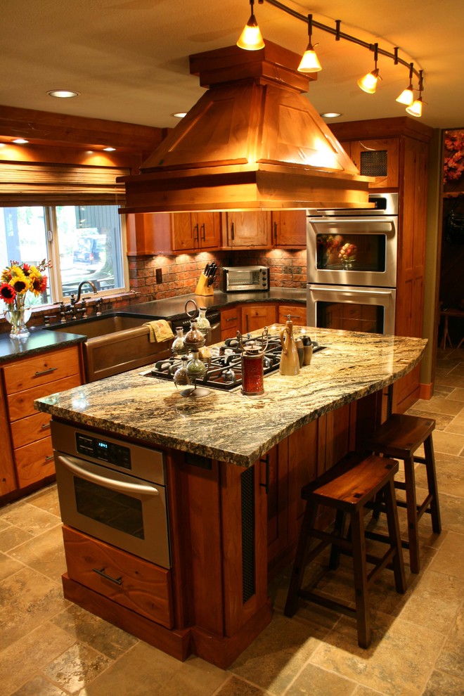 Inspiration for a timeless kitchen remodel in Portland with stainless steel appliances, granite countertops, a farmhouse sink, medium tone wood cabinets and subway tile backsplash