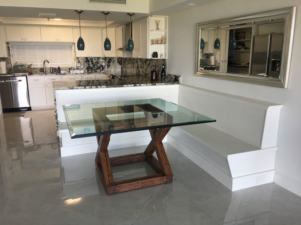 Example of a mid-sized trendy l-shaped marble floor eat-in kitchen design in Miami with a single-bowl sink, shaker cabinets, white cabinets, marble countertops, gray backsplash, stainless steel appliances and a peninsula