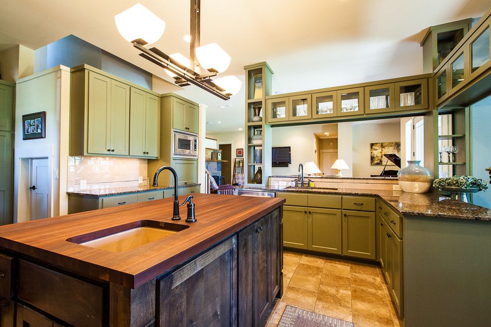 Example of a trendy kitchen design in Austin with granite countertops and green cabinets